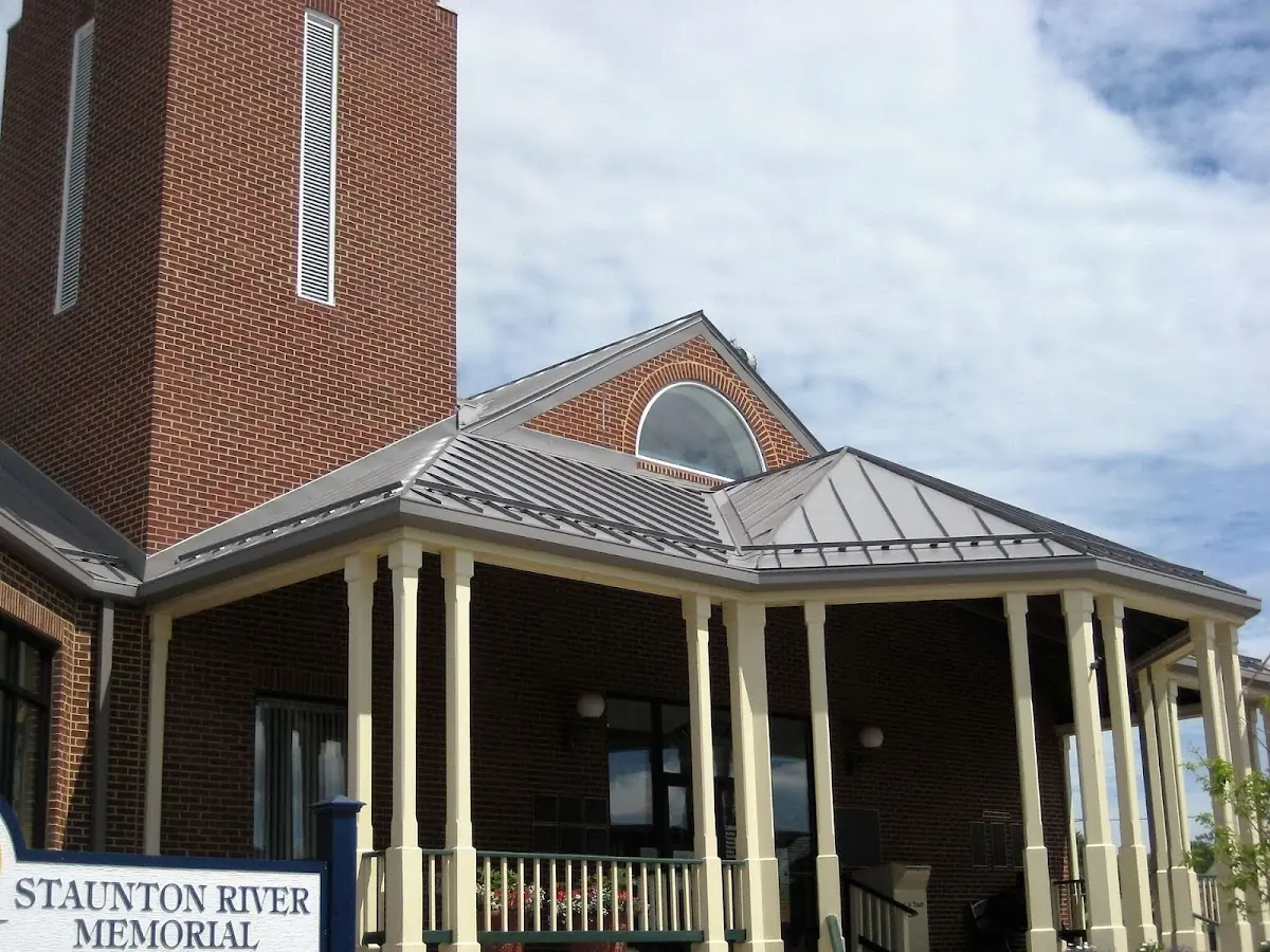 Skilled roofing craftsmen working on a residential roof in Bedford